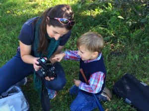 Liz teaches a young aspiring photographer.