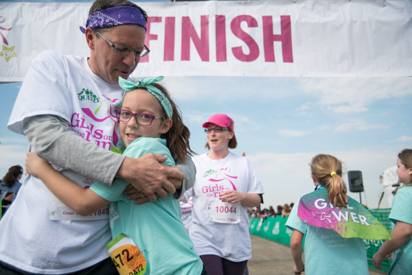 Dad hugs his daughter at the finish line of the Girls on the Run Chicago Southwest 5k